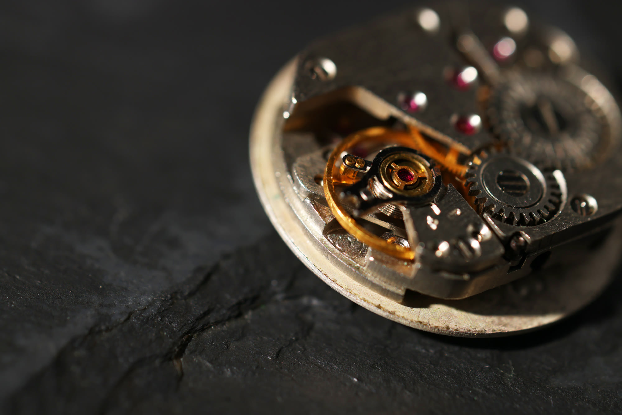 Mechanical watch movement resting on slate