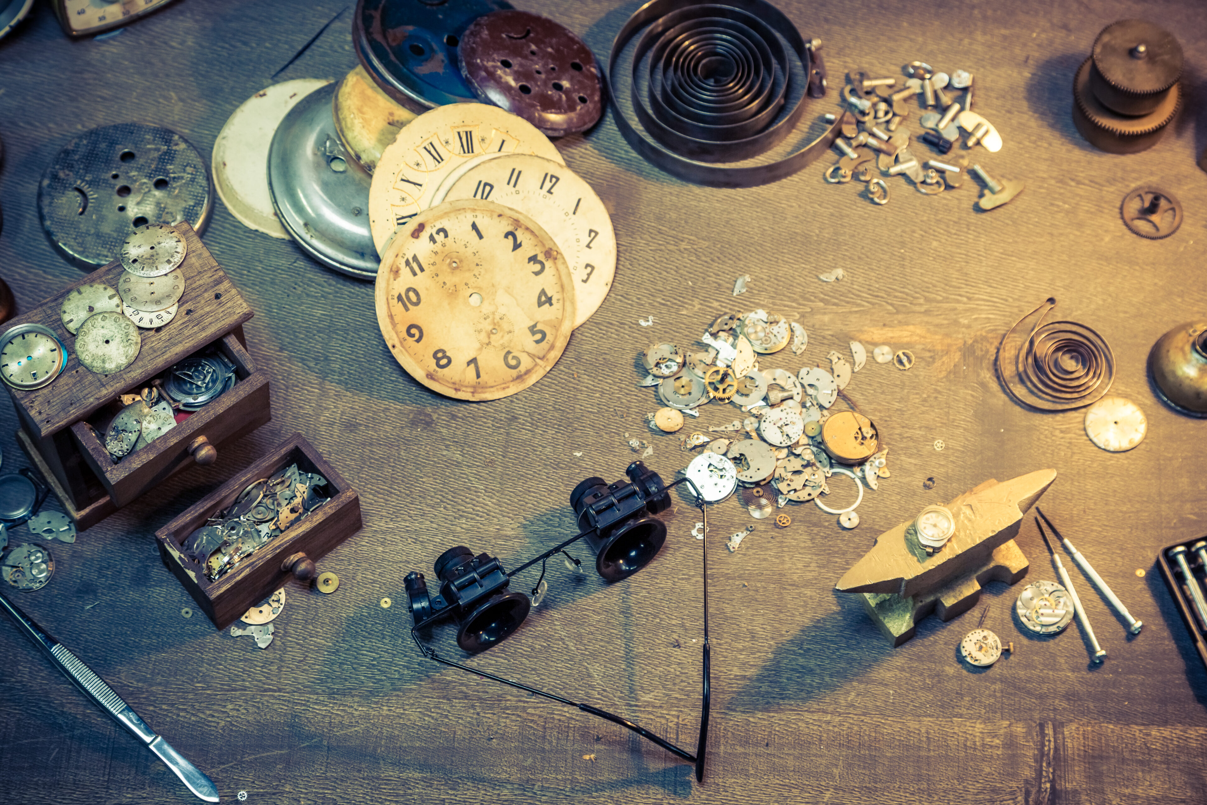 Vintage watch components on a watchmaker bench