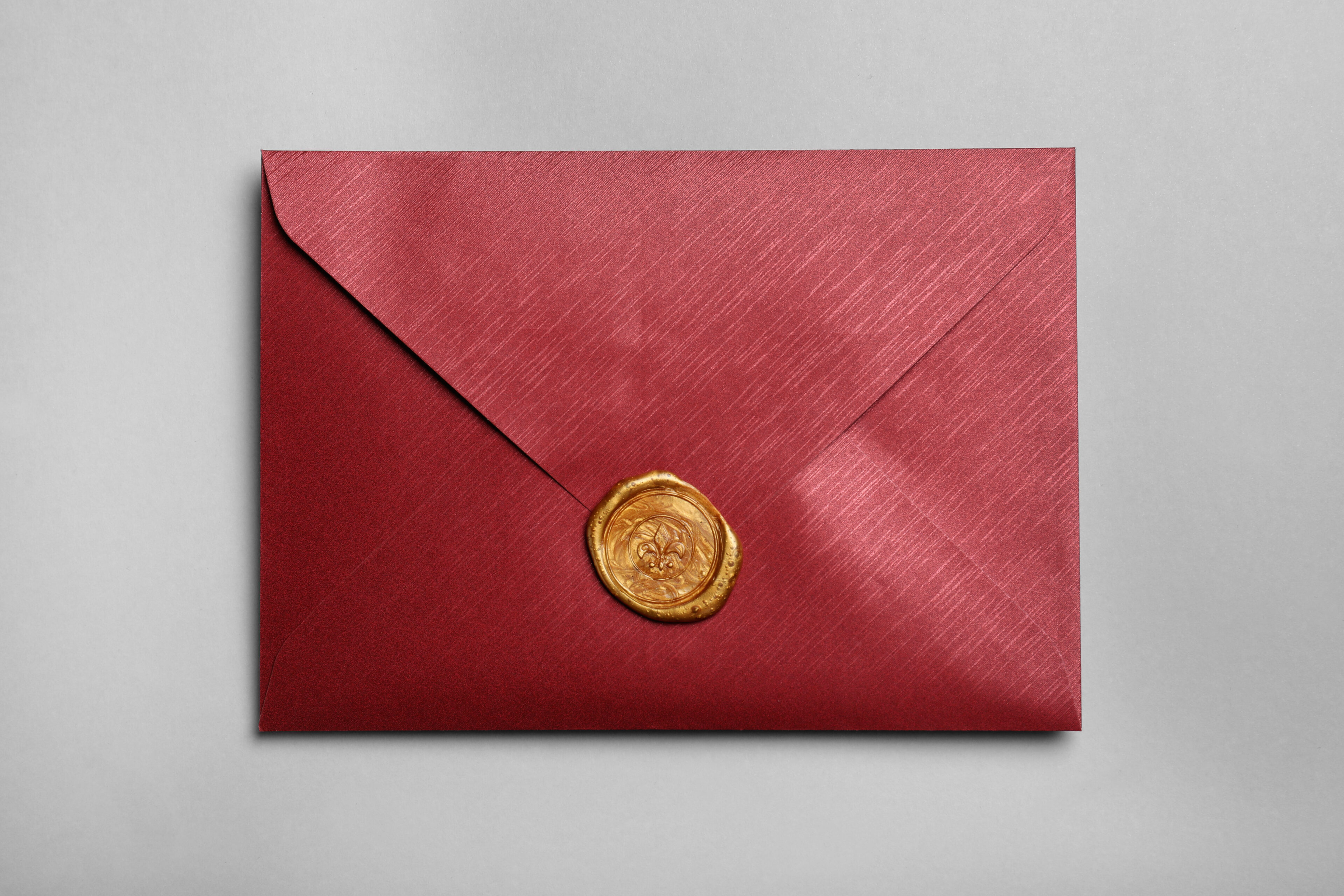 Burgundy envelope sealed with gold wax
